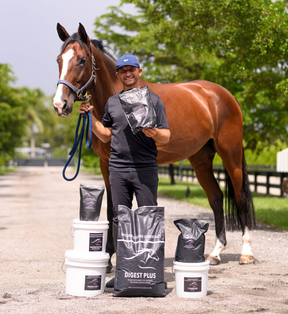 Photo of Alberto Michan posing with Horse and Natural Equine Essentials Products